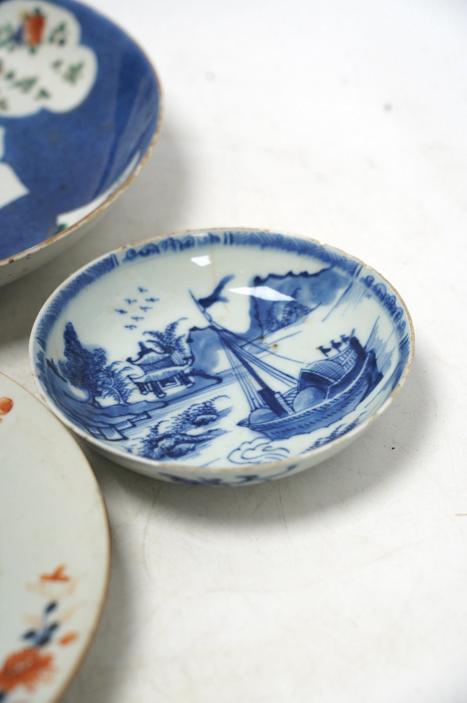 A Chinese powder blue famille verte dish, Kangxi period, a Yongzheng Imari plate and a Kangxi blue and white saucer, largest 22cm diameter. Condition - poor